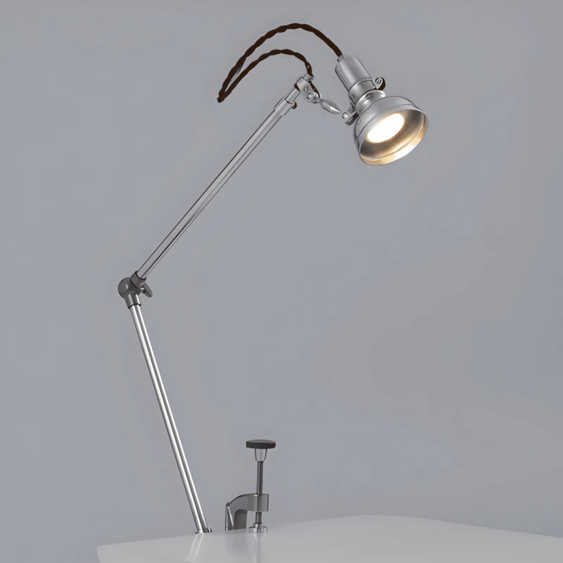 Lampe de Bureau LED Articulée Design Italien placée sur le côté d'un bureau gris