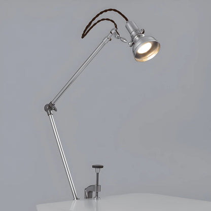 Lampe de Bureau LED Articulée Design Italien placée sur le côté d'un bureau gris